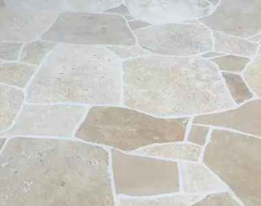 Ivory Travertine crazy paving grouted white.