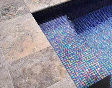 Silver oyster travertine bullnose used on steps into a pool